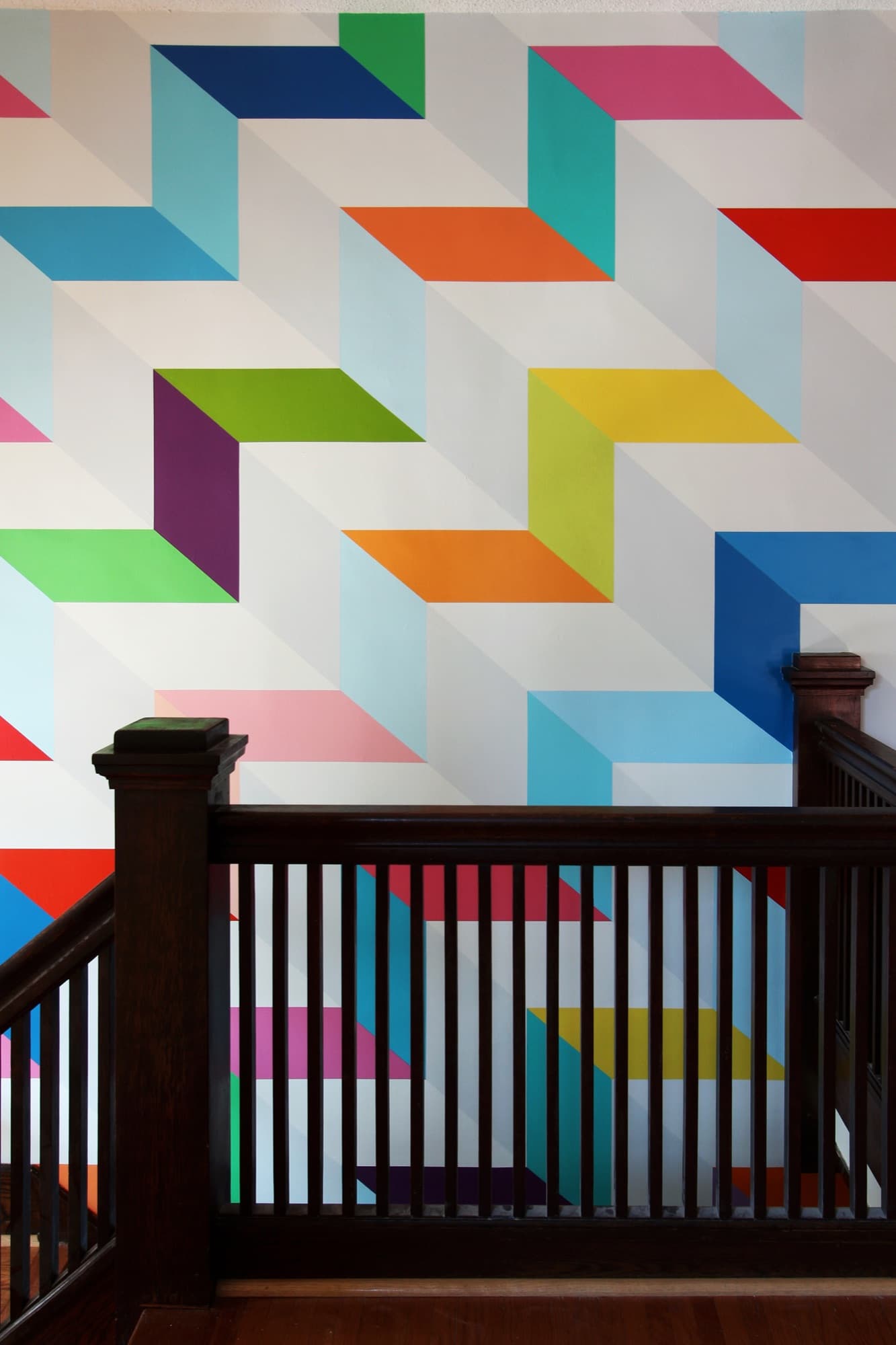 Chromatic Ascent — upper register, viewed from the staircase landing across the dark oak banister.