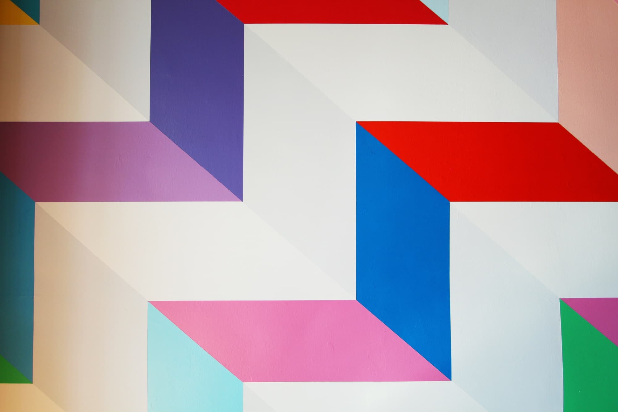 Chromatic Ascent — close detail of the overlapping parallelograms at the centre of the wall.