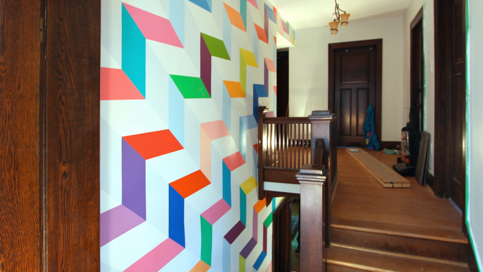 Chromatic Ascent — the same staircase wall after the mural was painted.