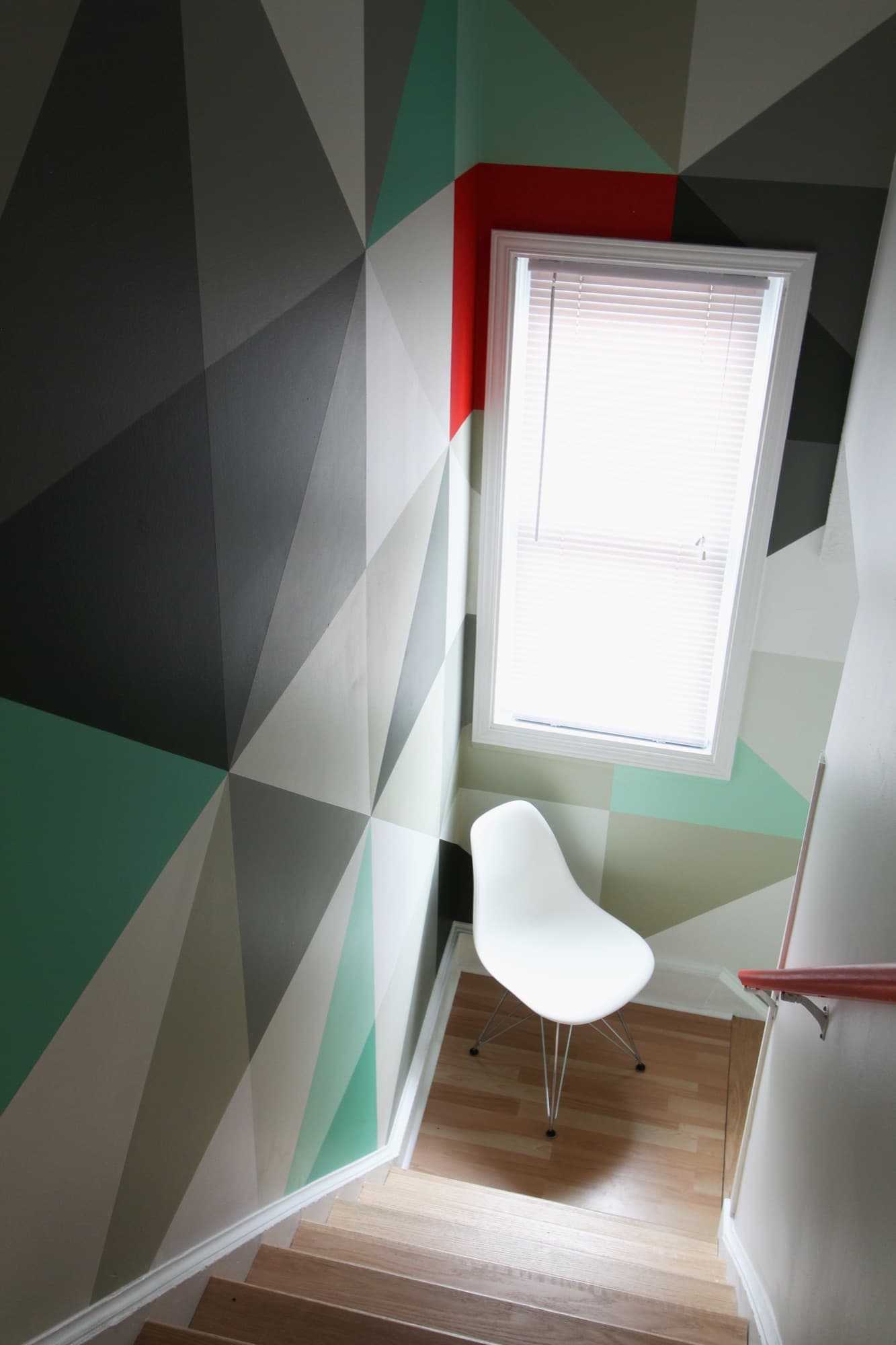 Mint & Vermillion — looking down the staircase, the window framed by the lone vermillion triangle.