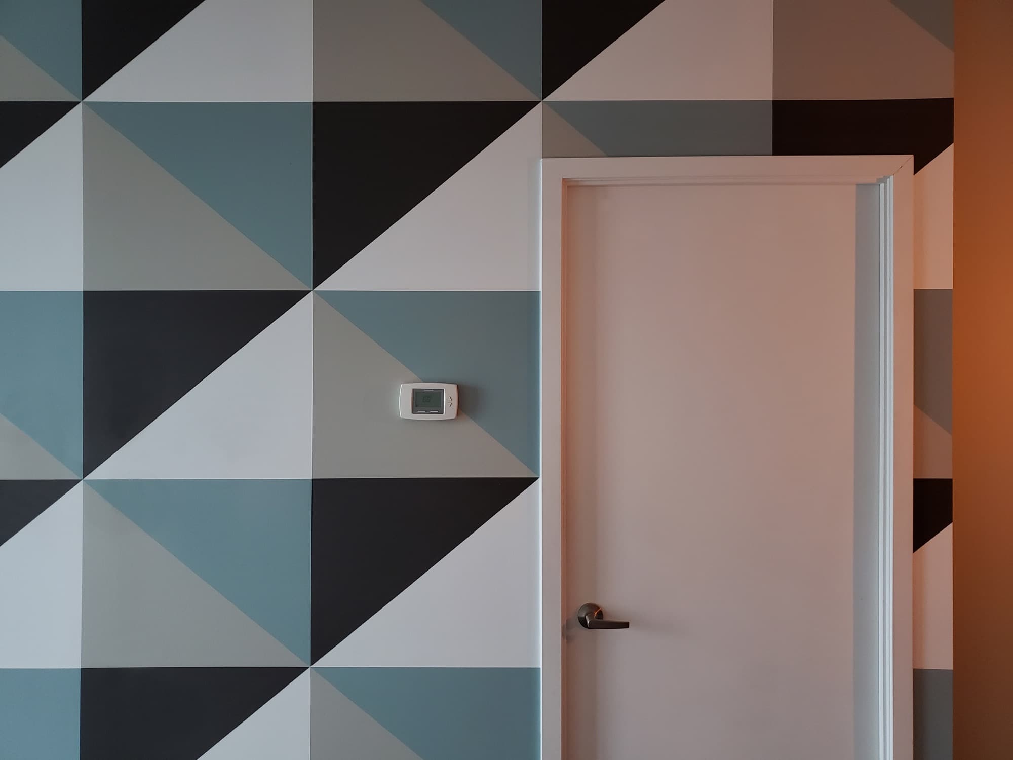 Quiet Composition — wide detail showing the triangulated pattern resolving around a doorway cut into the wall.